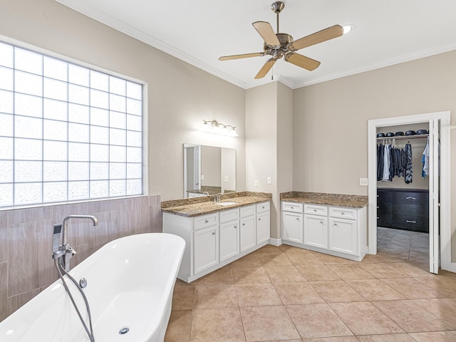 full bathroom with ceiling fan, tile patterned flooring, vanity, a freestanding bath, and ornamental molding