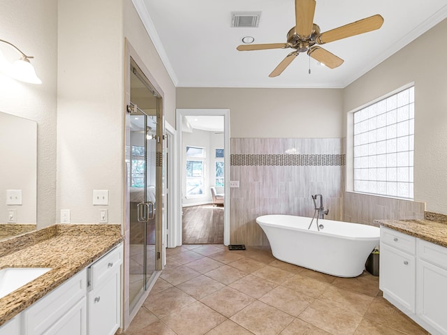 bathroom featuring tile walls, ornamental molding, vanity, ceiling fan, and tile patterned floors