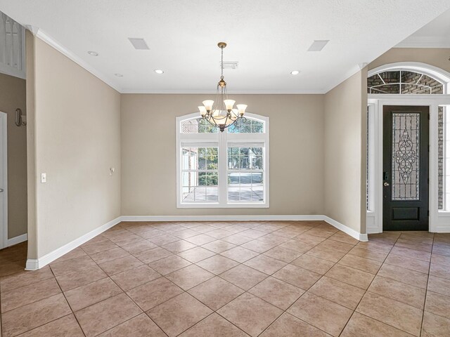 tiled foyer entrance with an inviting chandelier, crown molding, and a textured ceiling