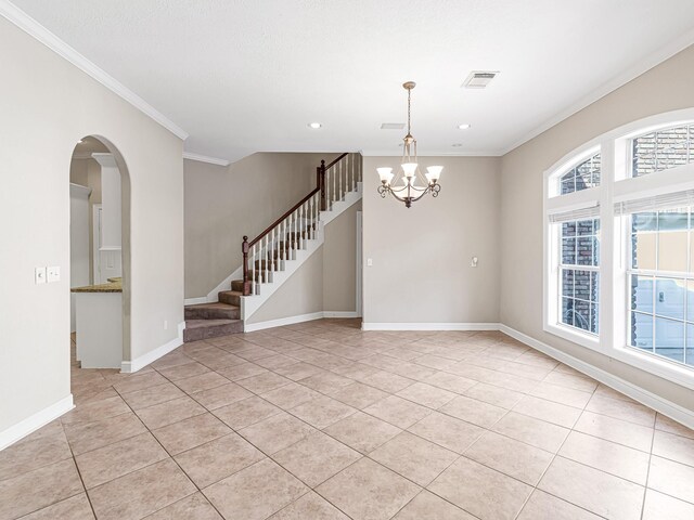 tiled empty room with crown molding and an inviting chandelier