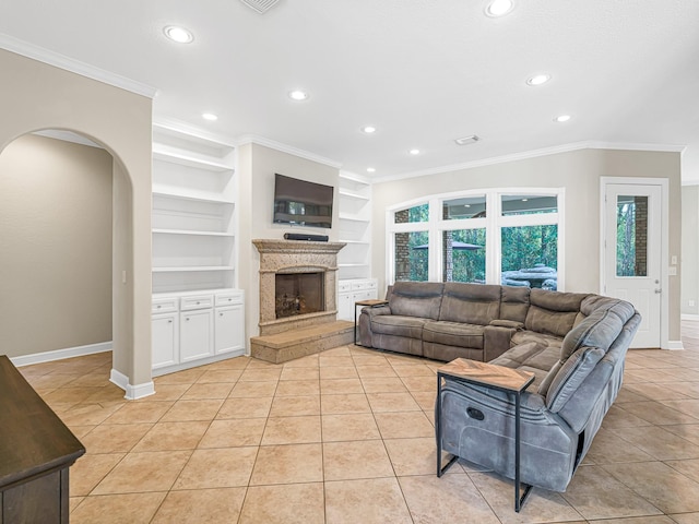 living room with built in shelves, arched walkways, crown molding, a premium fireplace, and light tile patterned flooring