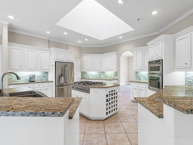 kitchen with appliances with stainless steel finishes and white cabinets