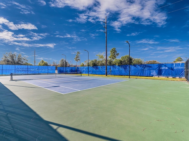 view of sport court with fence