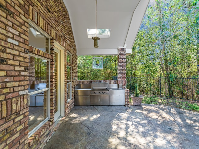 view of patio featuring fence and area for grilling