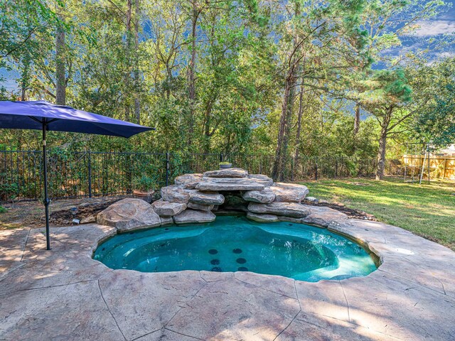 view of pool with a lawn, a fenced backyard, and a patio area