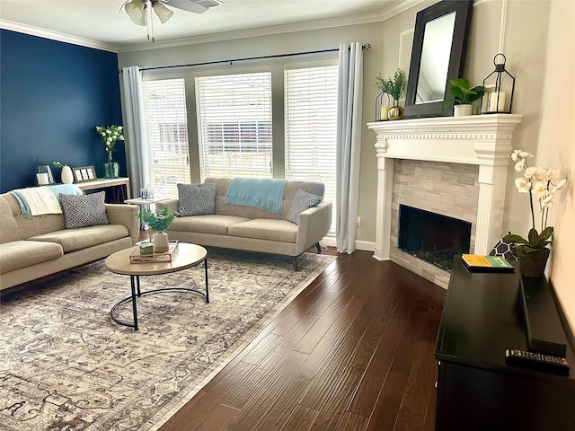 living room with ceiling fan, a fireplace, a wealth of natural light, and dark hardwood / wood-style flooring