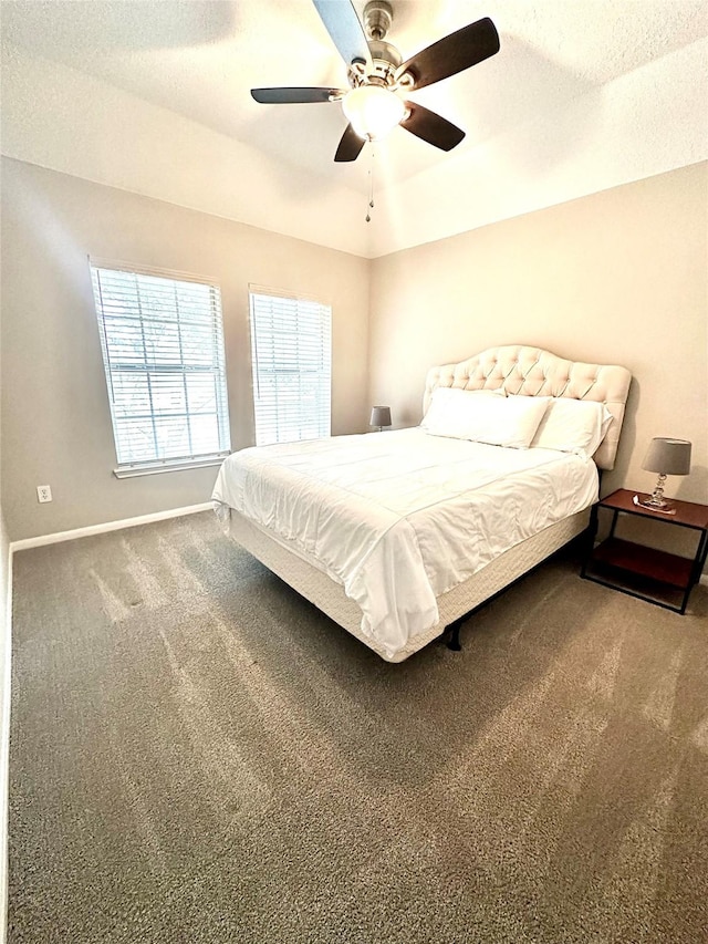 bedroom featuring a textured ceiling, ceiling fan, and carpet flooring