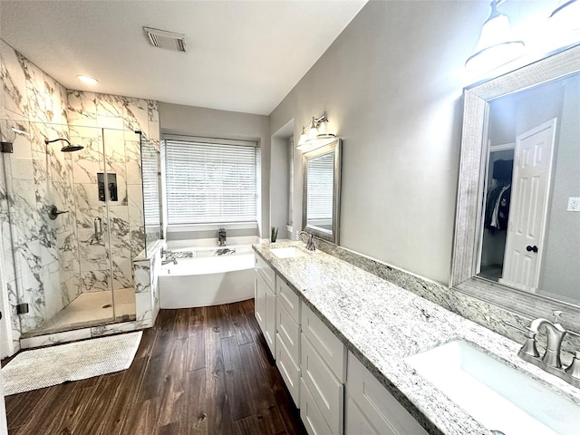 bathroom with vanity, hardwood / wood-style flooring, and shower with separate bathtub