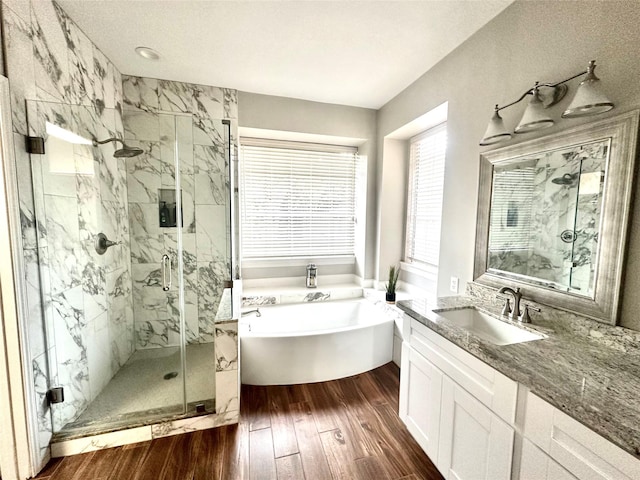 bathroom featuring vanity, shower with separate bathtub, and hardwood / wood-style floors