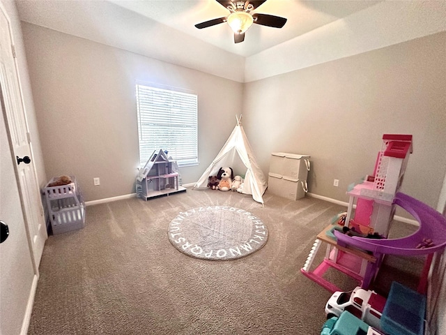 game room with ceiling fan, carpet flooring, and a raised ceiling