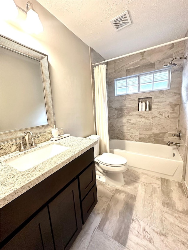 full bathroom featuring a textured ceiling, toilet, vanity, and shower / bath combo