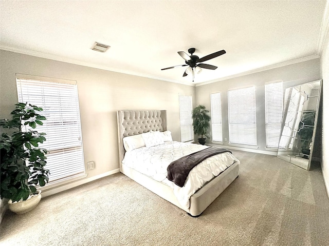 bedroom with ceiling fan, crown molding, and carpet floors