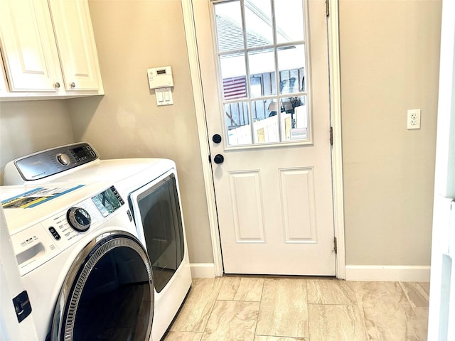 laundry area with cabinets and separate washer and dryer