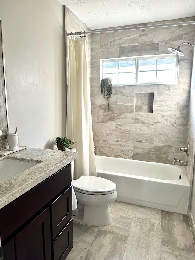 full bathroom with toilet, a textured ceiling, vanity, and shower / tub combo with curtain