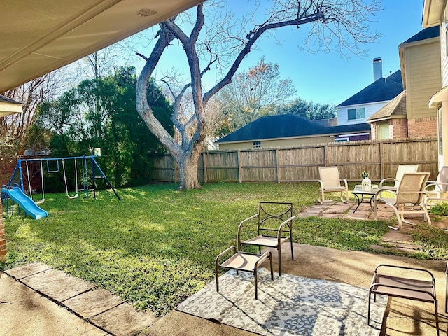 view of yard featuring a patio area and a playground