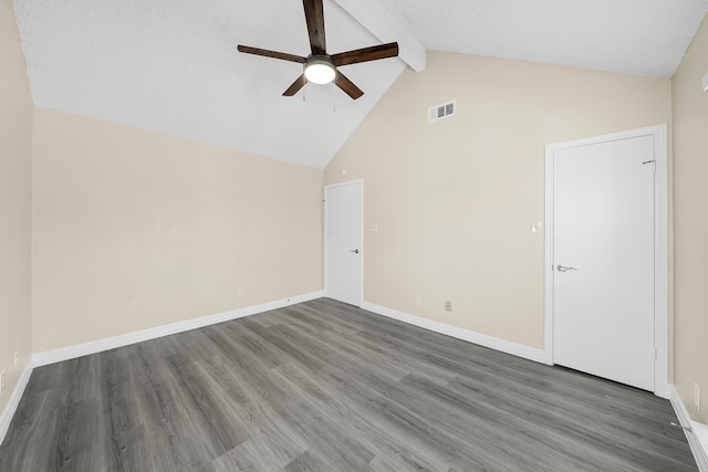 empty room featuring beam ceiling, dark hardwood / wood-style floors, high vaulted ceiling, and ceiling fan