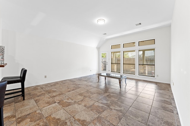 unfurnished room with lofted ceiling