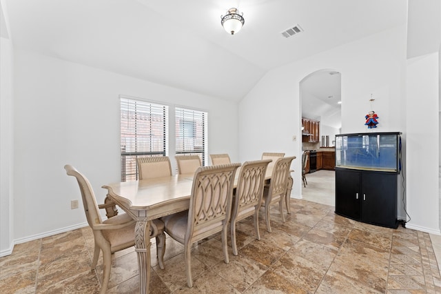 dining space featuring lofted ceiling