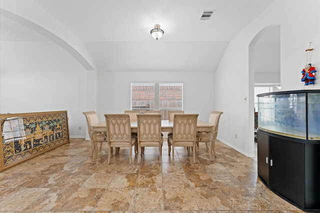 dining area with vaulted ceiling