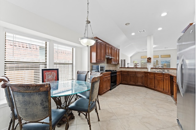 dining space with light tile patterned flooring, sink, and vaulted ceiling