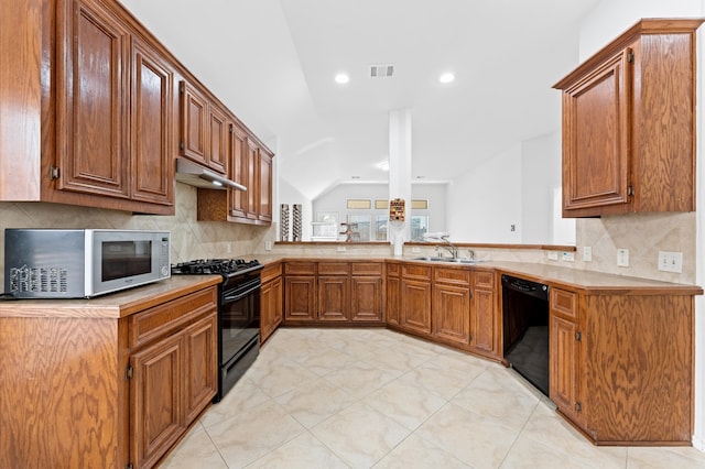 kitchen with lofted ceiling, black appliances, sink, and tasteful backsplash