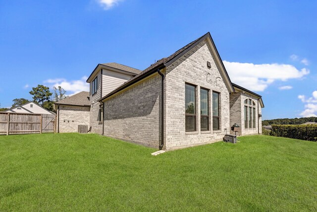 rear view of house featuring a yard