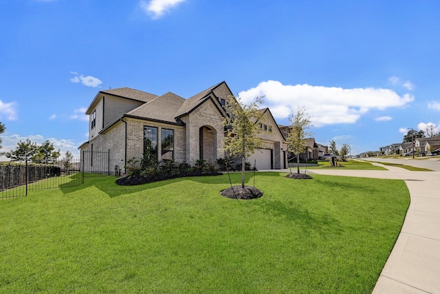 view of front of home featuring a front yard and a garage