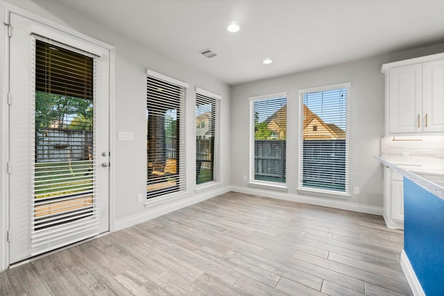 unfurnished dining area with light hardwood / wood-style floors