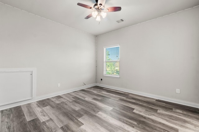 spare room featuring ceiling fan and hardwood / wood-style flooring