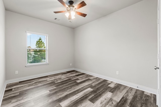 spare room featuring ceiling fan and dark hardwood / wood-style floors