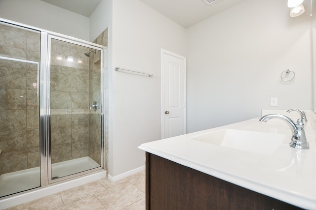 bathroom featuring vanity, tile patterned floors, and a shower with shower door