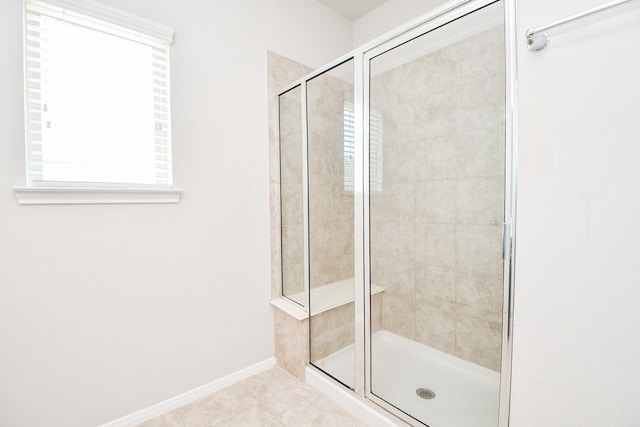 bathroom featuring walk in shower and tile patterned flooring