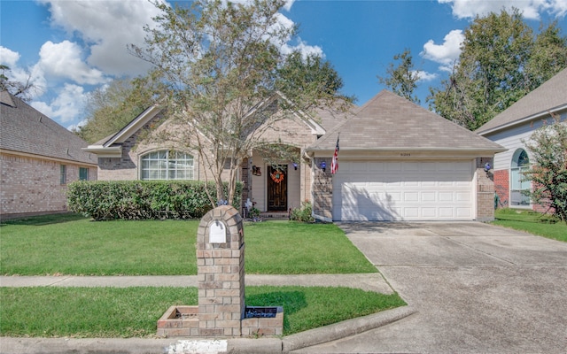 view of front facade with a front yard and a garage