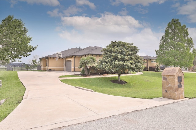 view of front of property featuring a front yard and a garage