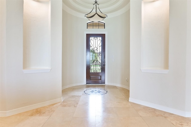 tiled foyer entrance with a high ceiling