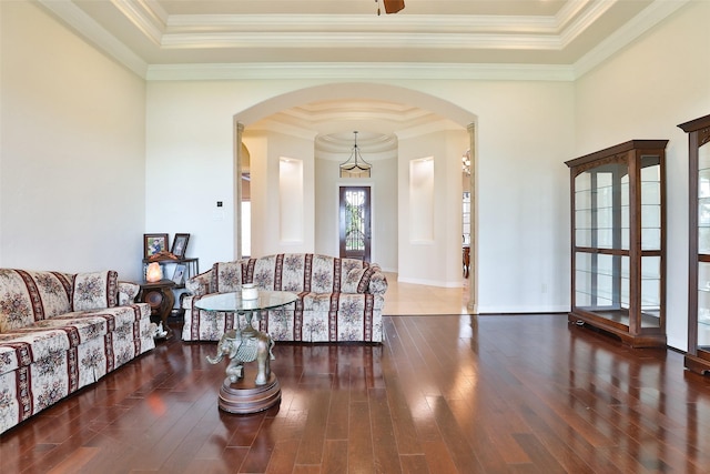 living room with dark wood-type flooring and ornamental molding