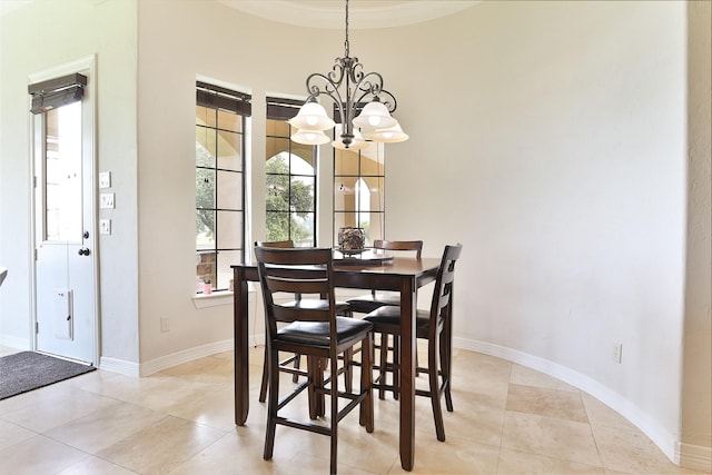 tiled dining room with an inviting chandelier