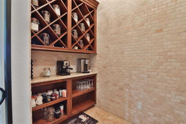 wine area featuring brick wall