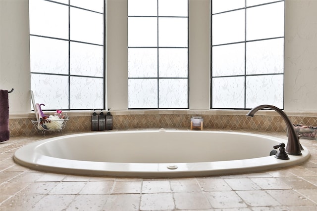 bathroom featuring tiled tub