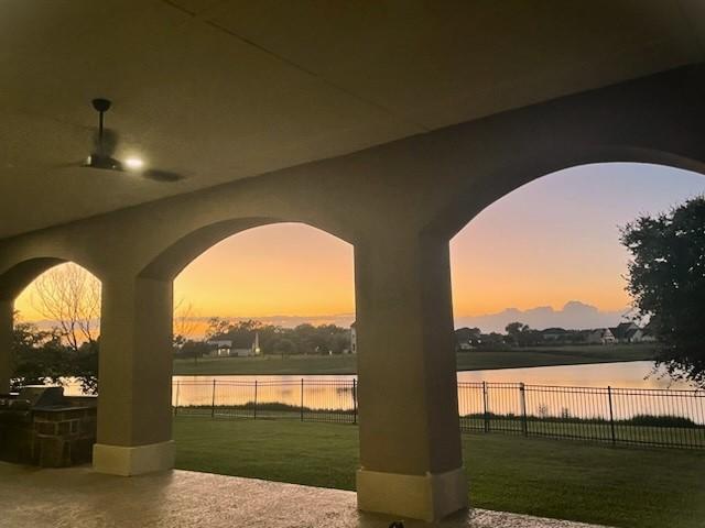 exterior space with a water view, a yard, and a patio