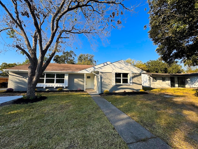 ranch-style home featuring a front yard