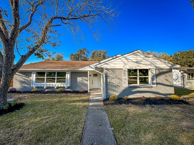 ranch-style home with a front lawn