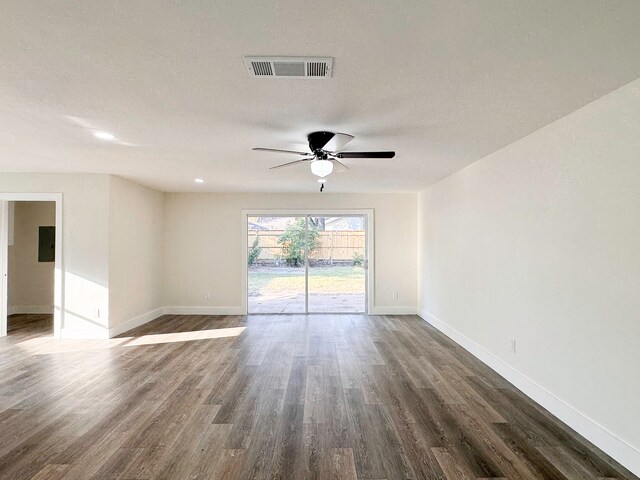 empty room with ceiling fan, a textured ceiling, and dark hardwood / wood-style flooring