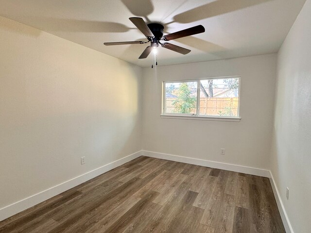 empty room featuring wood-type flooring and ceiling fan