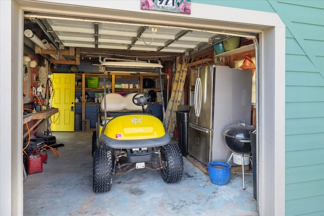 garage with stainless steel refrigerator with ice dispenser