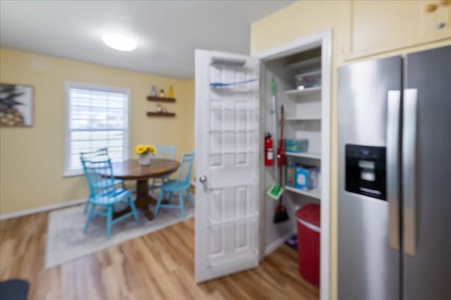 kitchen with stainless steel refrigerator with ice dispenser and hardwood / wood-style flooring