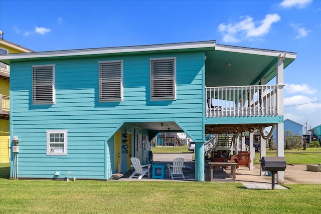 back of house featuring a patio and a lawn