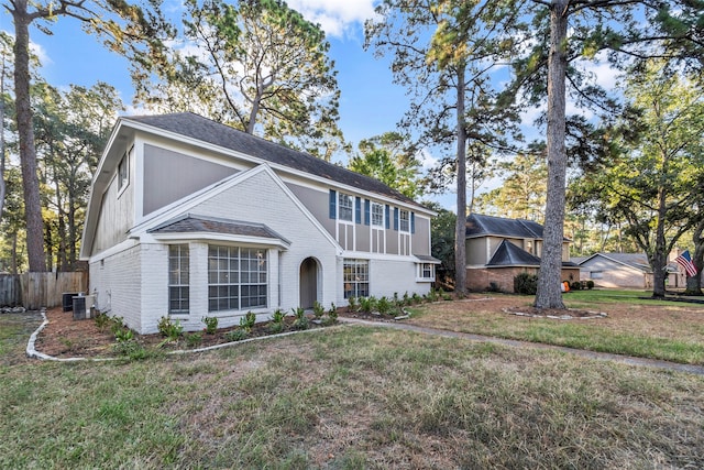 view of front facade with central AC and a front lawn