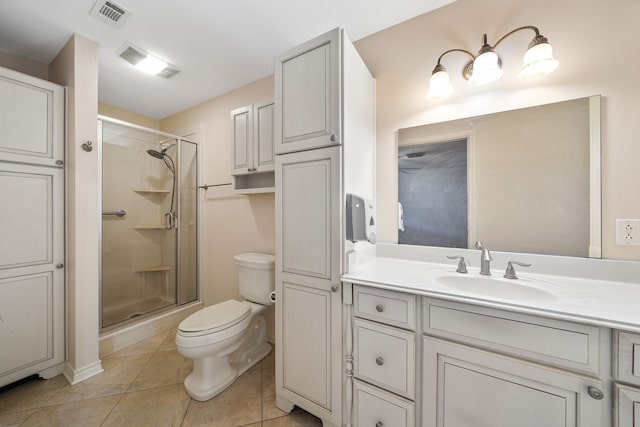 bathroom featuring toilet, a shower with shower door, vanity, and tile patterned floors