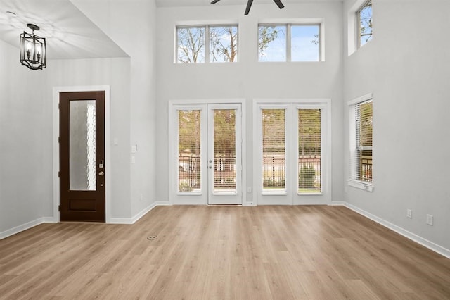 interior space with ceiling fan with notable chandelier